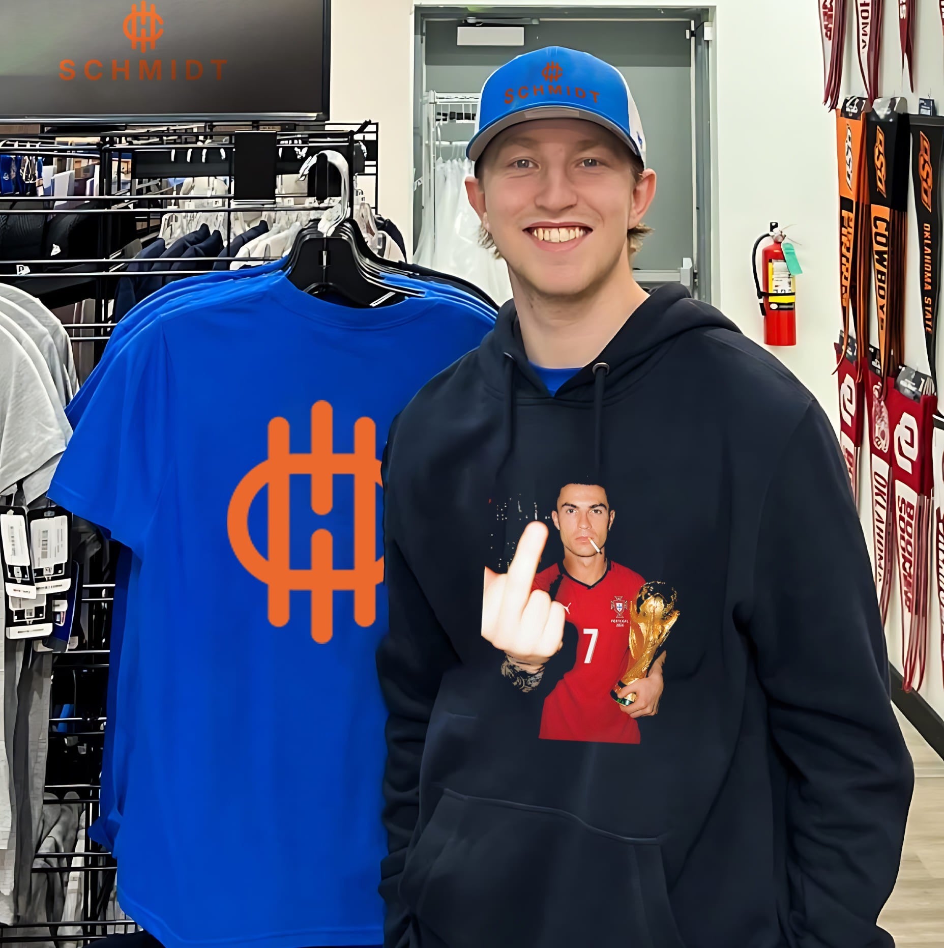 Cristiano Ronaldo holding trophy middle finger shirt