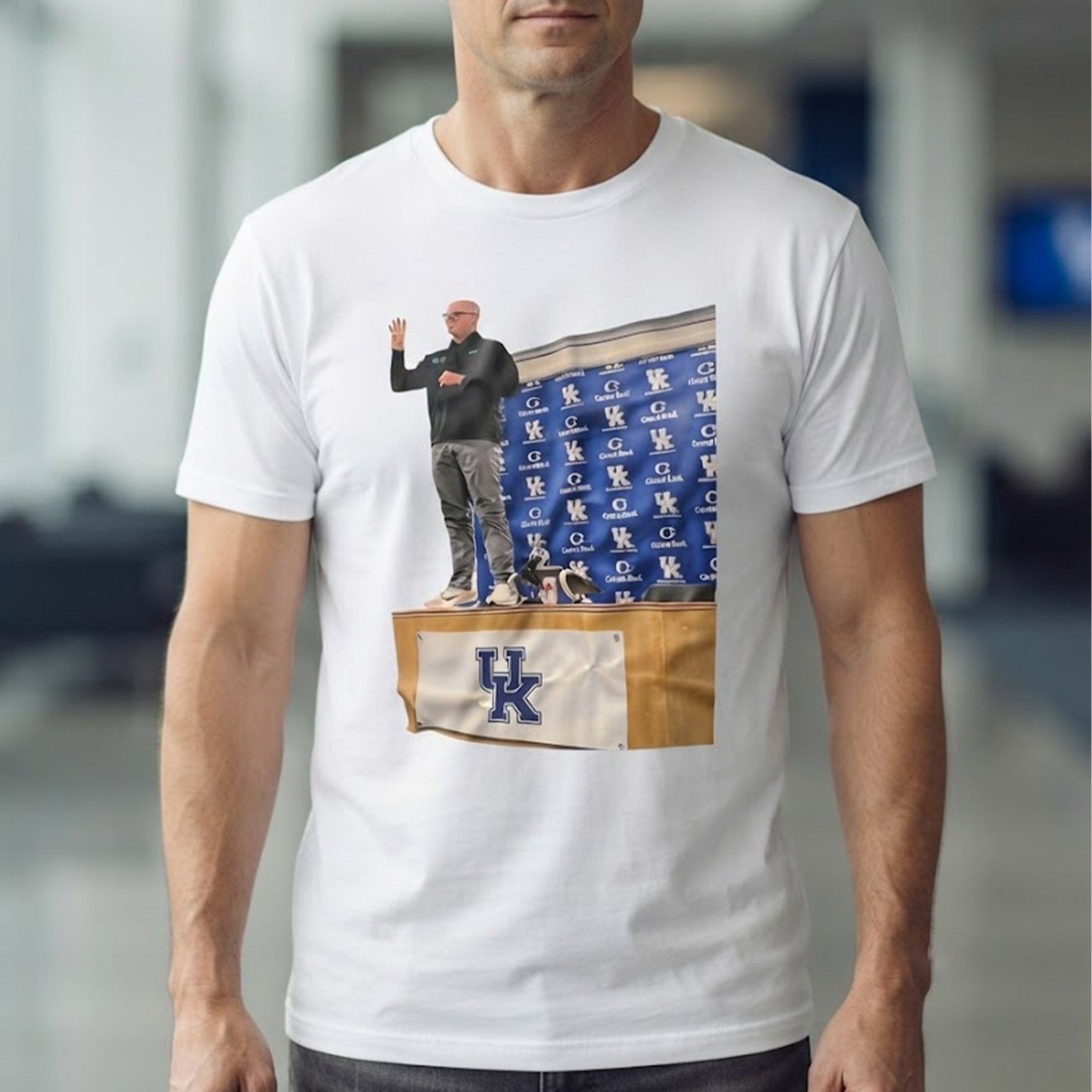 UK volleyball coach Craig Skinner stood on the table Shirt